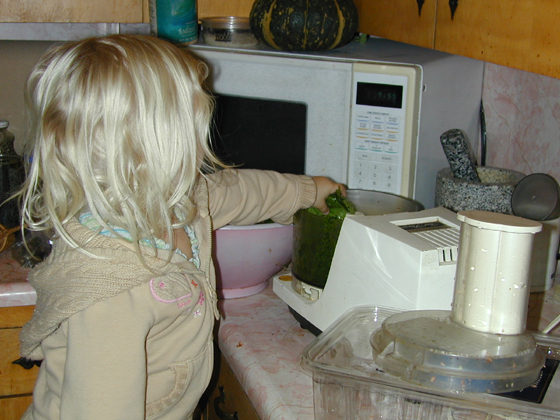 Miriam puts spinach into the food processor