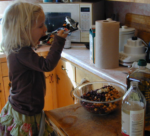 Miriam sneaks a bite while mixing the salad