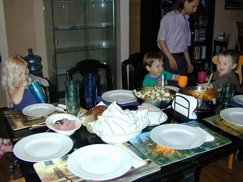 Miriam, Donavan, & Roxie ready to eat, with Michael in the background