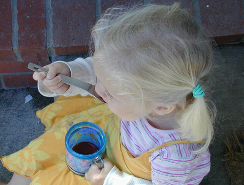 Miriam eating a raspberry slushie