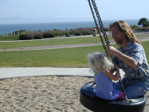 Miriam & Michael on the tire swing at Shell Beach