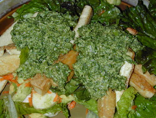 Pesto served over salad and tofu