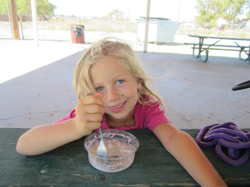 Miriam eating coconut tapioca pudding at our second food stop and first playground stop