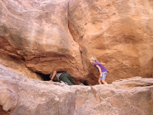 Miriam prepares to go through a tiny arch during the Fiery Furnace Tour at Arches National Park, Utah