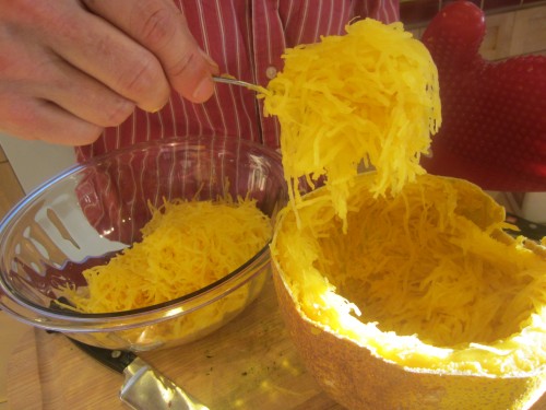 Scooping out spaghetti squash
